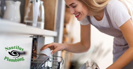 Woman loading dishwasher.