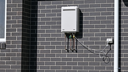 tankless water heater on brick wall