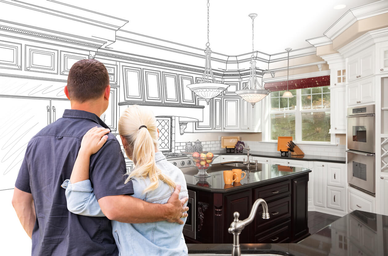 Couple with arms around each other deciding on kitchen remodel 