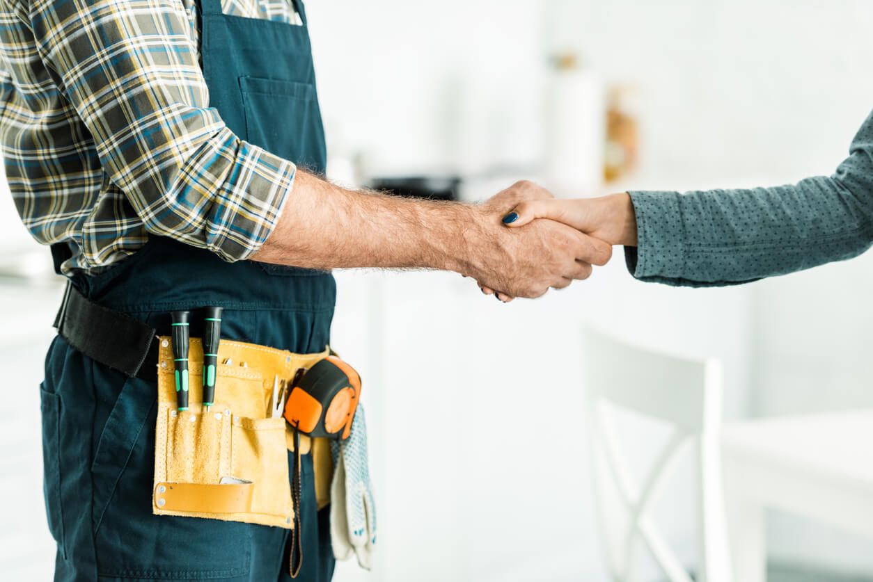 Plumber Shaking Hands with Client