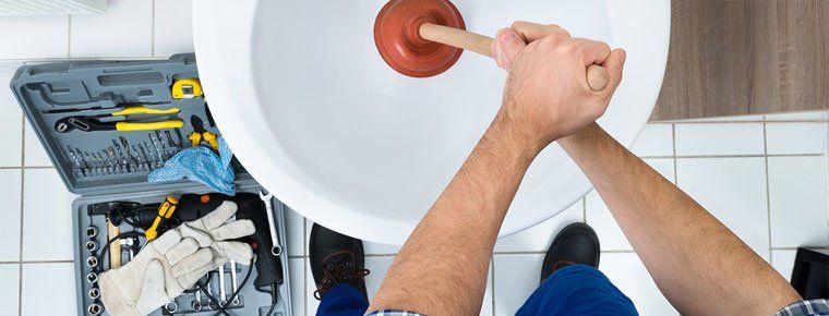 Person Plunging a Toilet